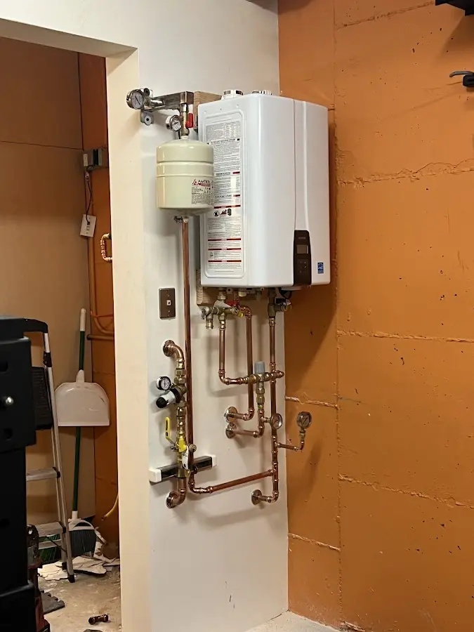 Plumbing technician inspecting water heater connections in Selinsgrove